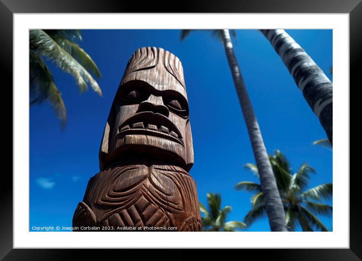 Tiki sculpture engraved in the wood Hawaiian religious motifs. A Framed Mounted Print by Joaquin Corbalan