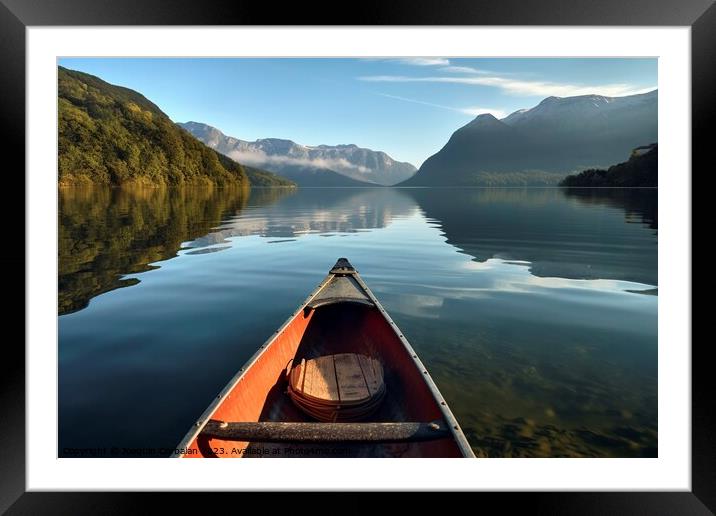 The morning mist cools the calm lake on which a lone canoe float Framed Mounted Print by Joaquin Corbalan