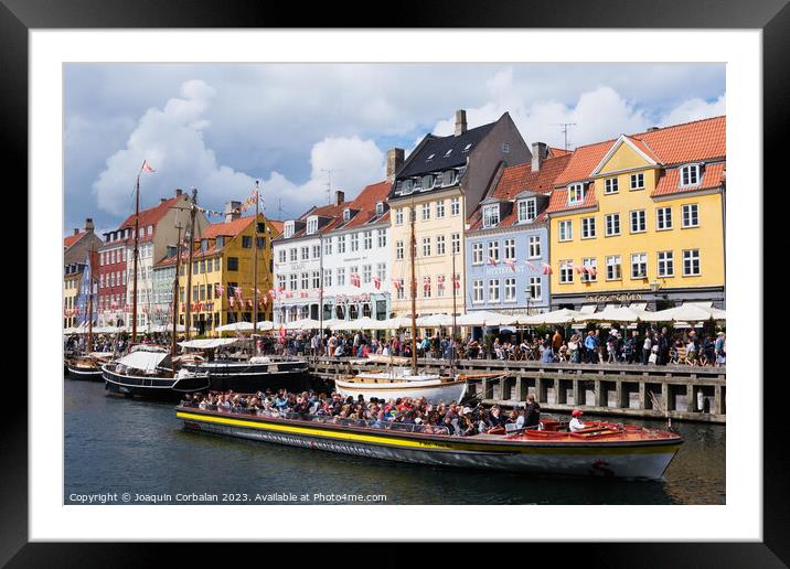 Copenhagen, Denmark - August 8, 2023: The most famous canal in Copenhagen with its quaint colorful houses overlooking the docked sailboats. Framed Mounted Print by Joaquin Corbalan