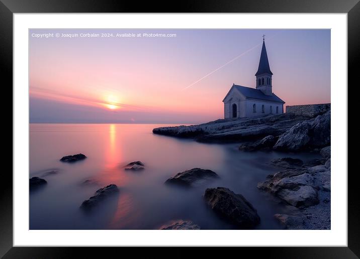 A church stands tall on a rocky shore next to the ocean, with the sunset on the horizon. Framed Mounted Print by Joaquin Corbalan