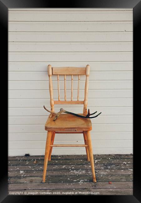 Old vintage wooden chair, with deer antlers Framed Print by Joaquin Corbalan