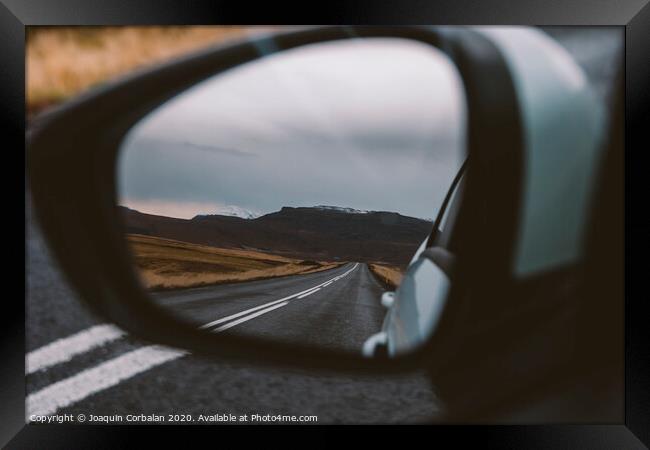 Scene of adventure travel in the mountains driving a car on the road with clouds and snow. Framed Print by Joaquin Corbalan