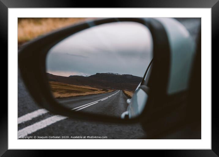 Scene of adventure travel in the mountains driving a car on the road with clouds and snow. Framed Mounted Print by Joaquin Corbalan