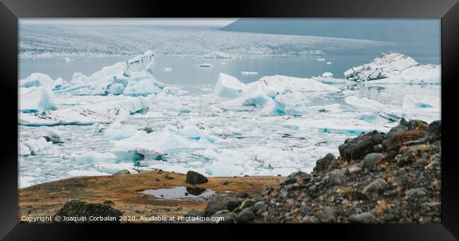Huge blocks of ice on Glacial river and blue icebergs on Jokulsarlon glacier lake. Vatnajokull National Park, Iceland. Framed Print by Joaquin Corbalan