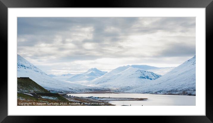 Beautiful and colorful blue skies with clouds and mountains in the background. Framed Mounted Print by Joaquin Corbalan