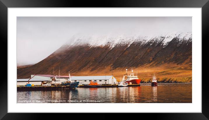 Fishing port of the village of Seydisfjordur, in Iceland, with vibrant colors and reflections in the sea of fishing boats. Framed Mounted Print by Joaquin Corbalan