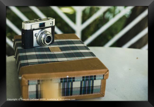 Old analog photo camera on a vintage travel suitcase. Framed Print by Joaquin Corbalan