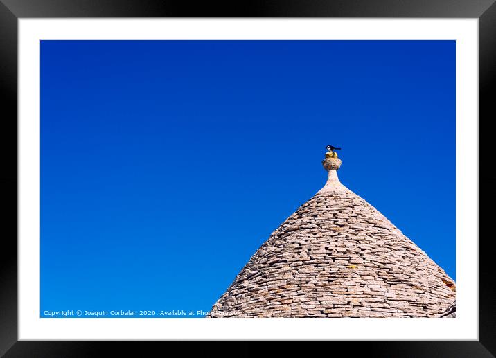 Stone tiles cover the roofs of the trulli in Alberobello, an Italian city to visit on a trip to Italy. Framed Mounted Print by Joaquin Corbalan
