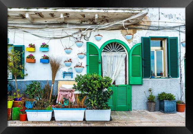 Facades of old Italian Mediterranean houses in Bari painted in colors. Framed Print by Joaquin Corbalan