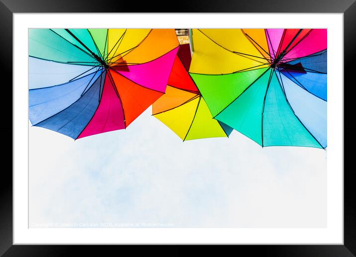 Colorful umbrellas to use as a background in bright and cheerful ideas. Framed Mounted Print by Joaquin Corbalan