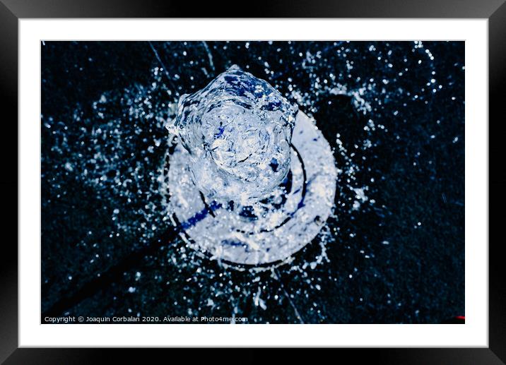 Fresh water jet from a vertical fountain to cool in summer Framed Mounted Print by Joaquin Corbalan