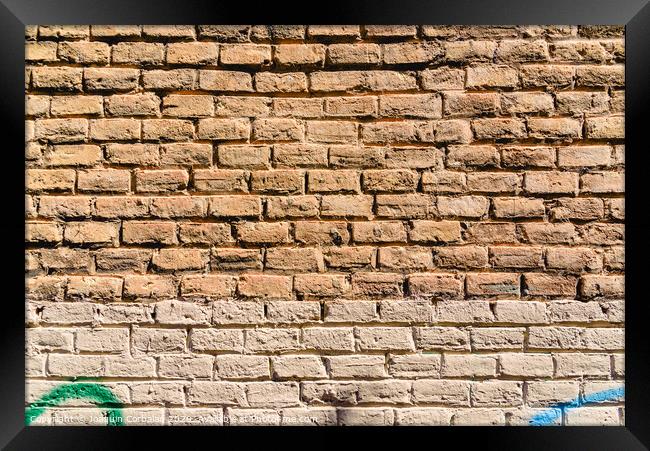 Texture of a brick wall painted in orange tones, ideal for background with space for free text. Framed Print by Joaquin Corbalan