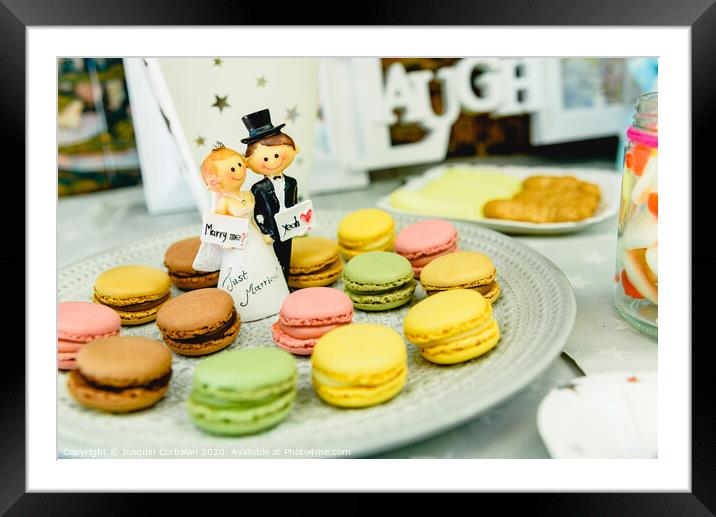 Happy newlywed dolls on a plate with macarons in the candy bar of a wedding. Framed Mounted Print by Joaquin Corbalan