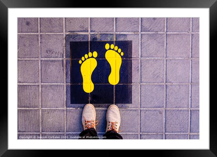 Foot standing on a street a safe way mark for children on the way to school. Framed Mounted Print by Joaquin Corbalan