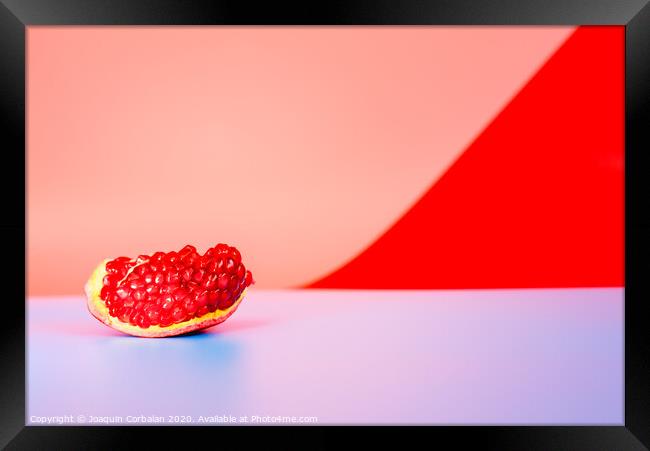 Autumn is the time of pomegranates, open fruit isolated on plain colored backgrounds. Framed Print by Joaquin Corbalan