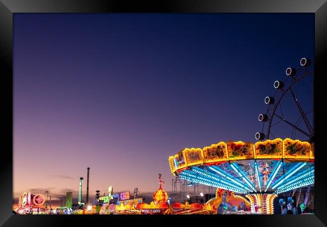 Amusement park at dusk with ferris wheel in the background. Framed Print by Joaquin Corbalan