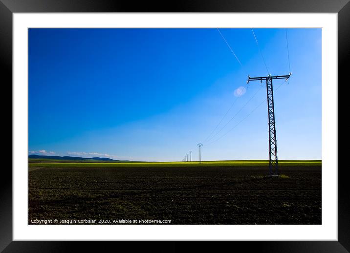 View of a colorful farming field with electricity towers Framed Mounted Print by Joaquin Corbalan