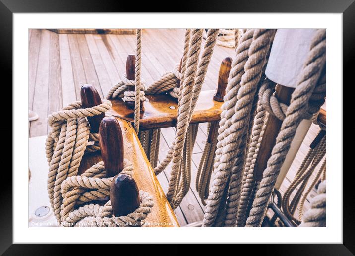 Boat mooring ropes wound on a sailboat. Framed Mounted Print by Joaquin Corbalan