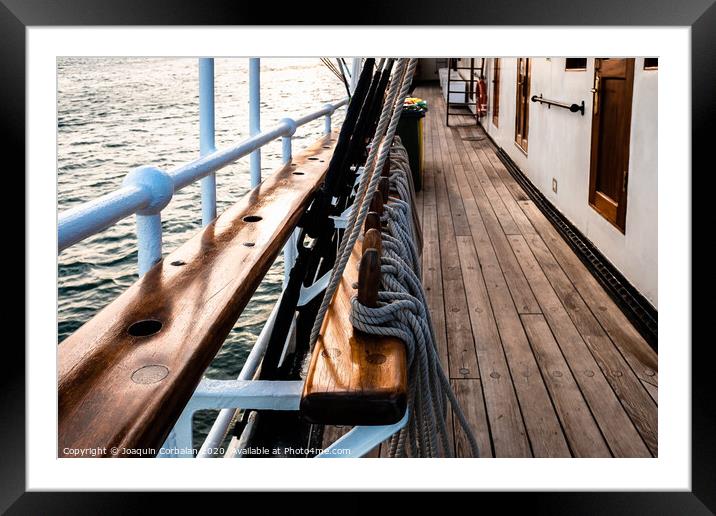 Beautiful  old sailboat anchored in the sea. Framed Mounted Print by Joaquin Corbalan