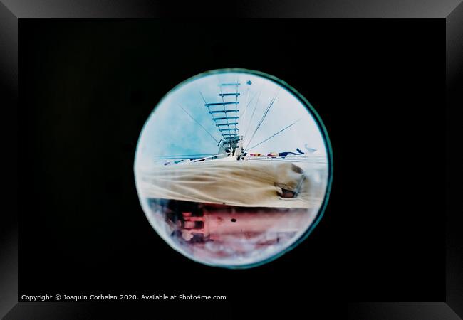 Ship moored to port seen through from inside the porthole of a ship. Framed Print by Joaquin Corbalan