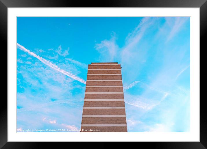 High housing building with blue sky in the background and copy space. Framed Mounted Print by Joaquin Corbalan
