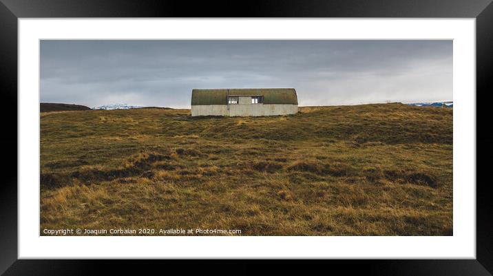 Abandoned warehouse in a wasteland near a meadow. Framed Mounted Print by Joaquin Corbalan