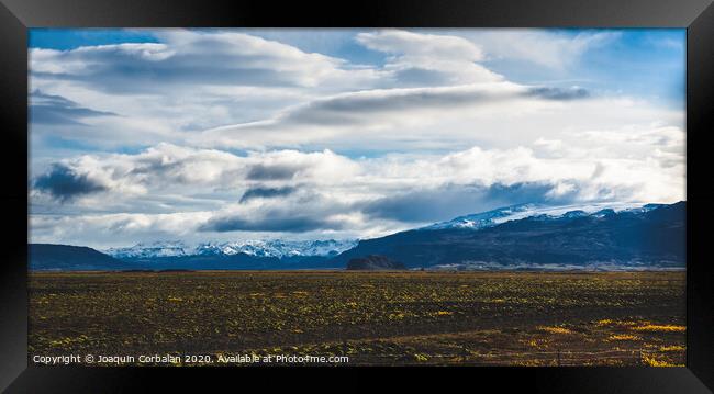 Beautiful and colorful blue skies with clouds and mountains in the background. Framed Print by Joaquin Corbalan