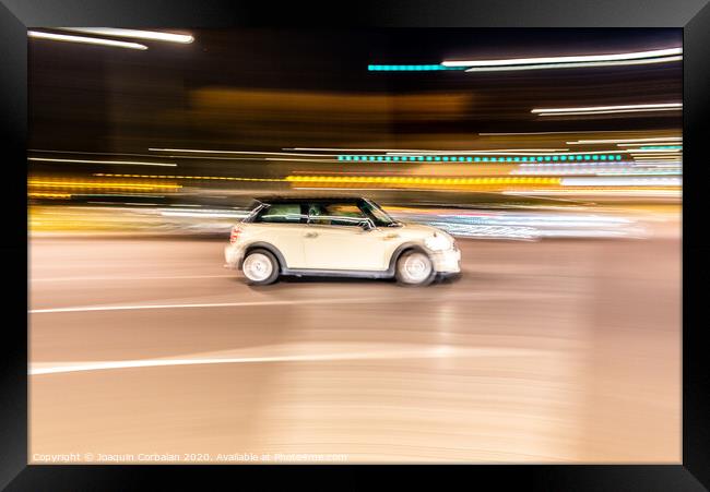 Car rolling at full speed through the city at night, image of panning, with defocused background lights. Framed Print by Joaquin Corbalan