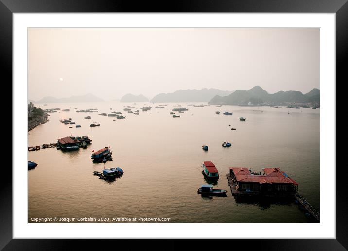 Vietnamese bay with boats plying the sea between mountains and rocks at sunset Framed Mounted Print by Joaquin Corbalan