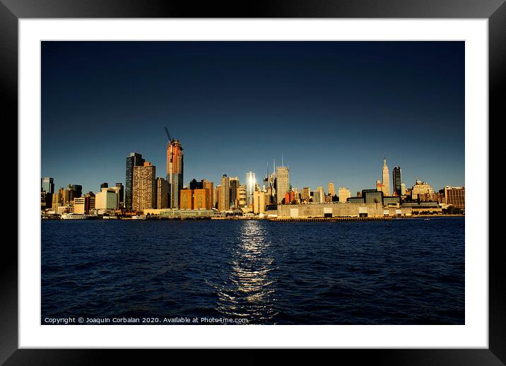view of Riverside Park next to the city skyline at sunset from the Hudson River. Framed Mounted Print by Joaquin Corbalan