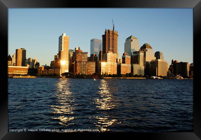  View of Riverside Park next to the city skyline at sunset from the Hudson River. Framed Print by Joaquin Corbalan