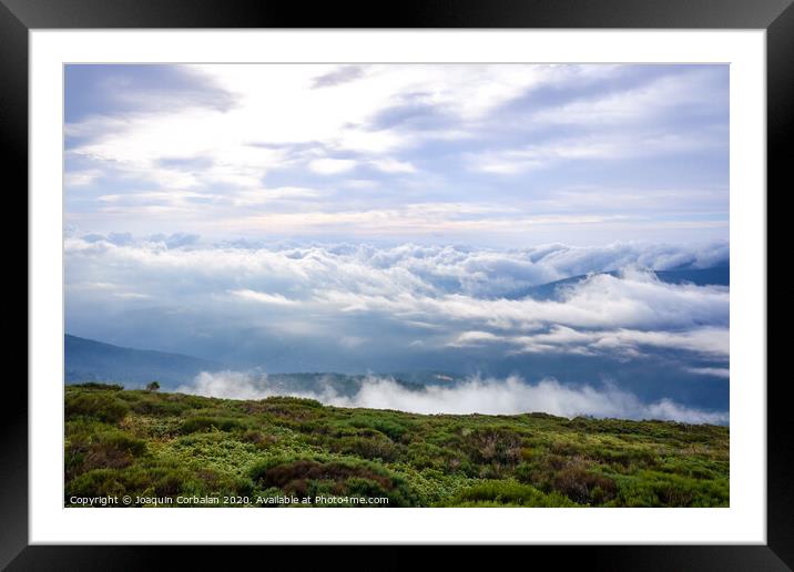 Scene of a winter cloudy sky from the top of a mountain peak. Framed Mounted Print by Joaquin Corbalan