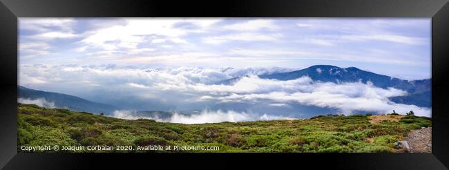 Panoramic image of the views of the Sierra de Guadarrama with its clouds from the top of a mountain peak. Framed Print by Joaquin Corbalan