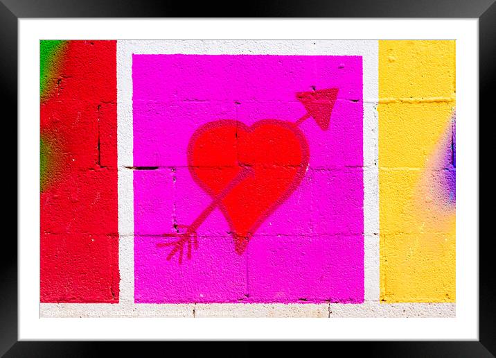 Heart pierced by a red arrow painted on a framed mural. Framed Mounted Print by Joaquin Corbalan