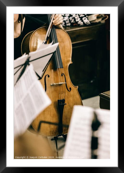 Violoncello held by a musician during a break at a classical music concert. Framed Mounted Print by Joaquin Corbalan