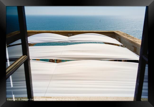 Serene sea seen from the window of a summer residence in the Mediterranean. Framed Print by Joaquin Corbalan