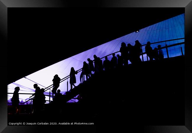 Silhouette of people going down a ladder, visitors of a tourist attraction, background defocused. Framed Print by Joaquin Corbalan