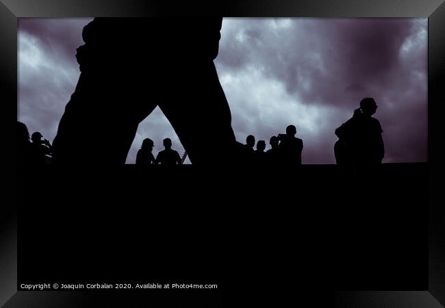Backlight of a cloudy day with a silhouettes of a group of unrecognizable people. Framed Print by Joaquin Corbalan