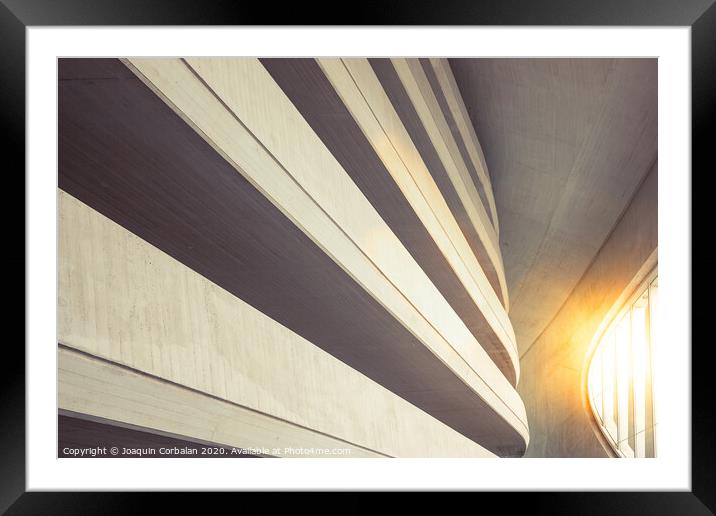 Warm tones background of the interior of a minimalist construction of rough textured walls and lines, illuminated with a sunbeam at sunset. Framed Mounted Print by Joaquin Corbalan