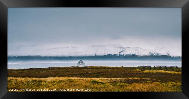 Icelandic landscapes full of green grass, sea and blue sky. Framed Print by Joaquin Corbalan