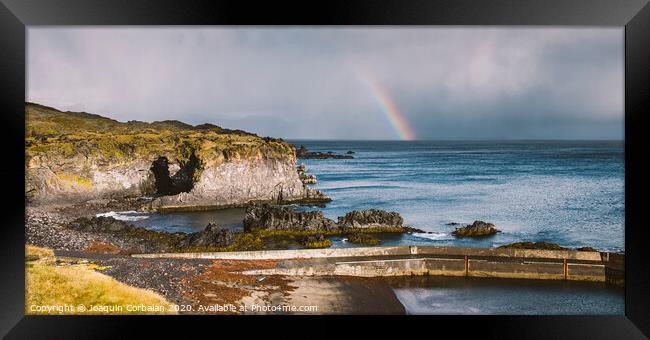 Rainbow over the Icelandic coast in the middle of nature. Framed Print by Joaquin Corbalan