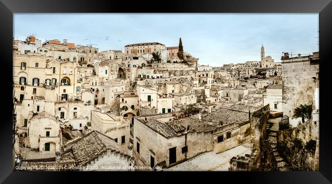 Panoramic view of Matera (Sassi di Matera) with its steep ancient stone streets, European Capital of Culture 2019, with clouds, at southern Italy, waiting to welcome tourists. Framed Print by Joaquin Corbalan