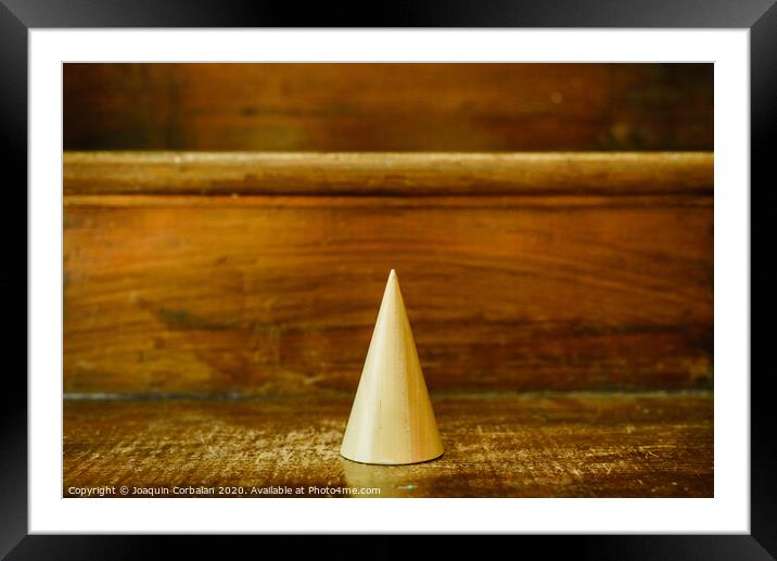 Cone shapes of solid wood to study geometry Framed Mounted Print by Joaquin Corbalan