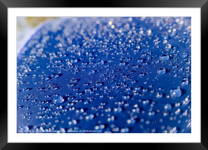Detail of water drops on a plastic fabric colored in the sun. Framed Mounted Print by Joaquin Corbalan