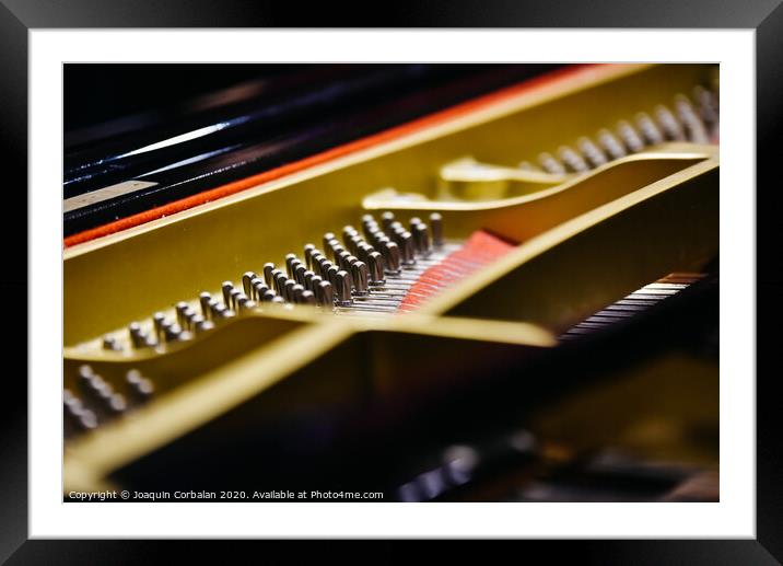 Detail of the interior of a piano with the soundboard, strings and pins. Framed Mounted Print by Joaquin Corbalan