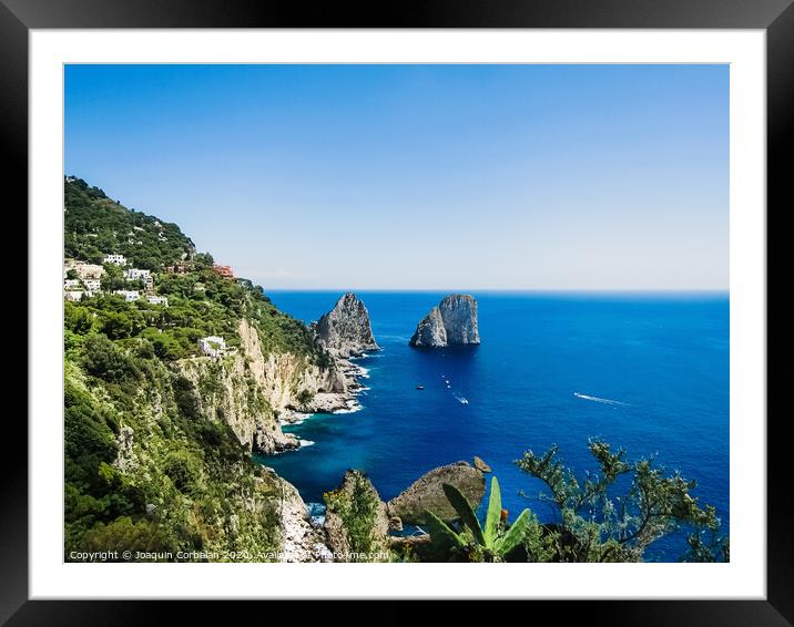 Natural rock arches and cliffs on the coast Sorrento and Capri, Italian islands with crystal clear waters where tourist boats crowd to photograph them in summer. Framed Mounted Print by Joaquin Corbalan