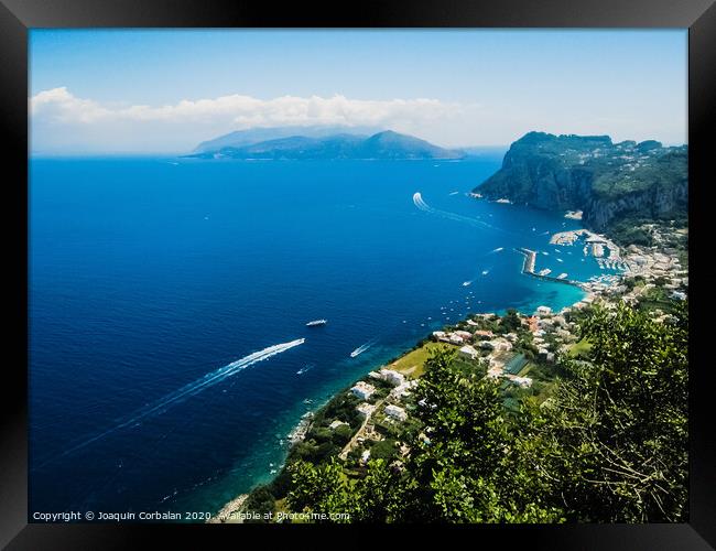 Sorrento, Italy - June 5, 2019: View from the sea of this picturesque Italian Mediterranean city, with old and colorful houses built on the side of a hill. Framed Print by Joaquin Corbalan
