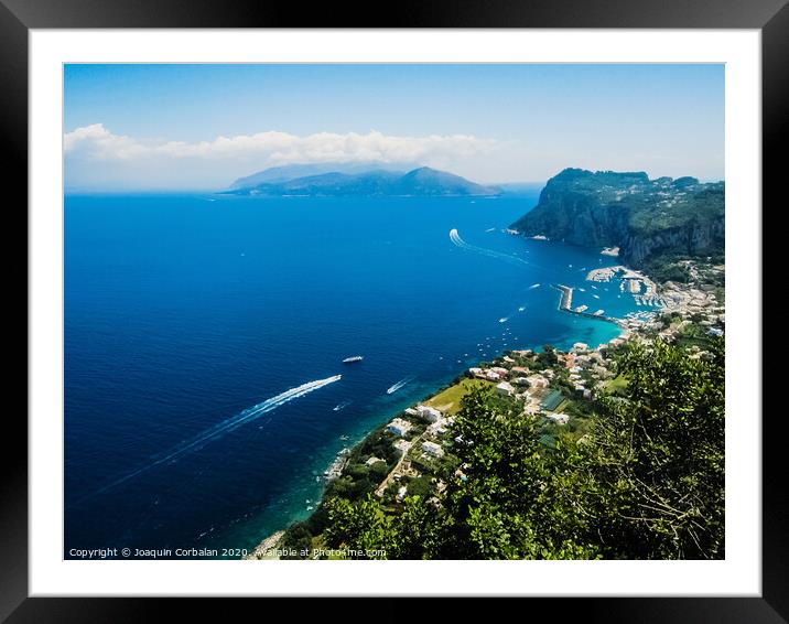 Sorrento, Italy - June 5, 2019: View from the sea of this picturesque Italian Mediterranean city, with old and colorful houses built on the side of a hill. Framed Mounted Print by Joaquin Corbalan