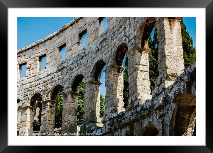 Roman amphitheater in Pula, the best preserved ancient monument in Croatia, visited by hundreds of tourists. Framed Mounted Print by Joaquin Corbalan
