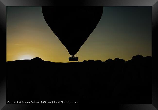 Silhouette of travelers and tourists flying over mountains at sunset in an aerostatic balloon. Framed Print by Joaquin Corbalan